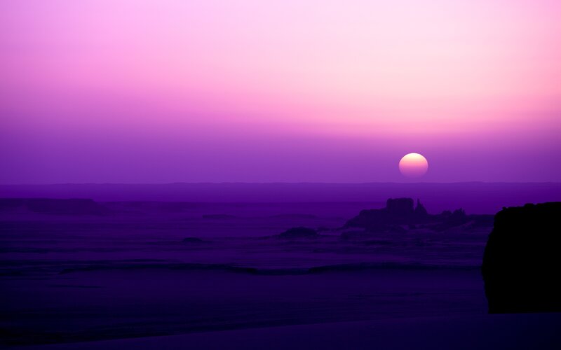 Purple sunset over desert