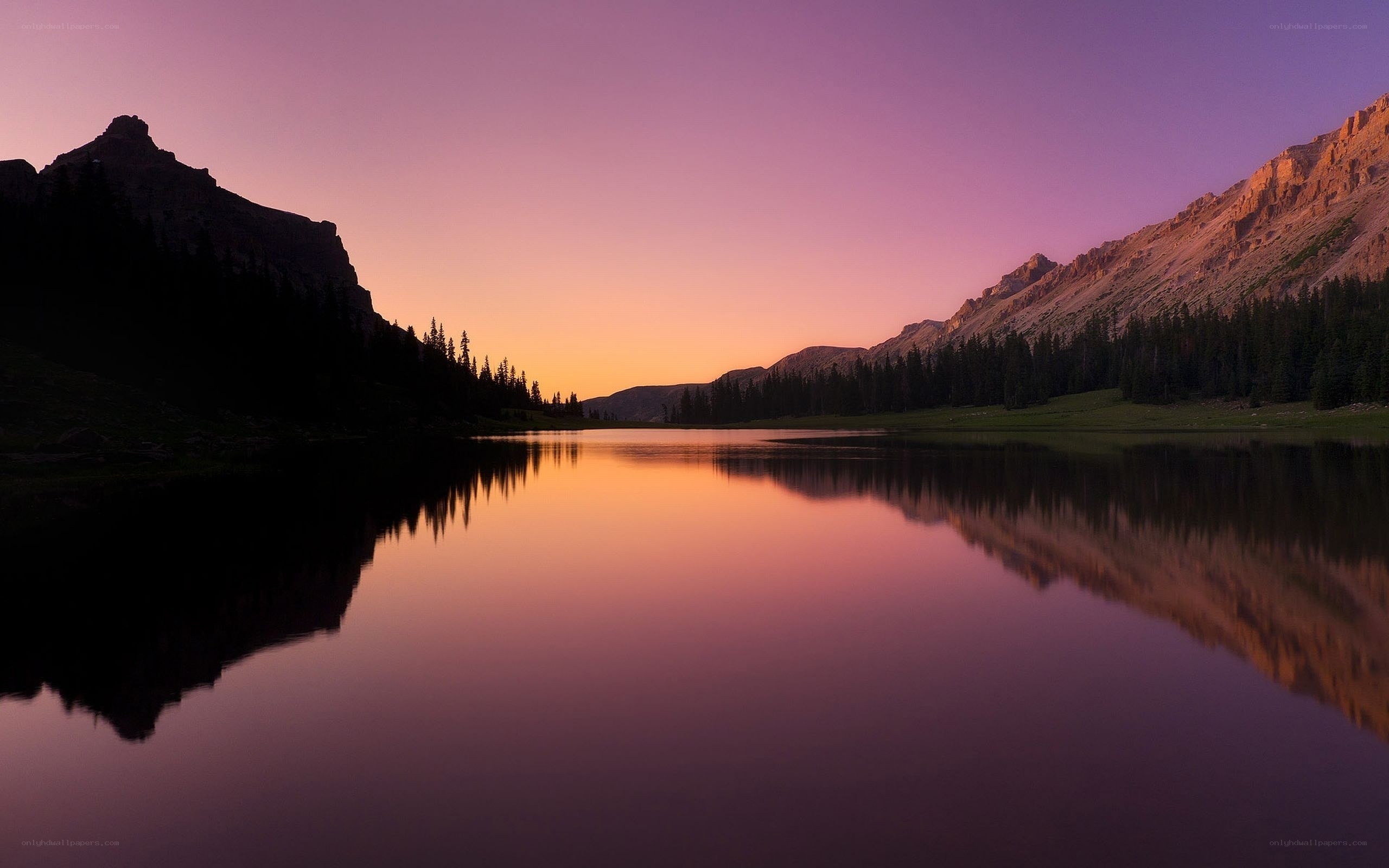 Purple sunset over mountain lake
