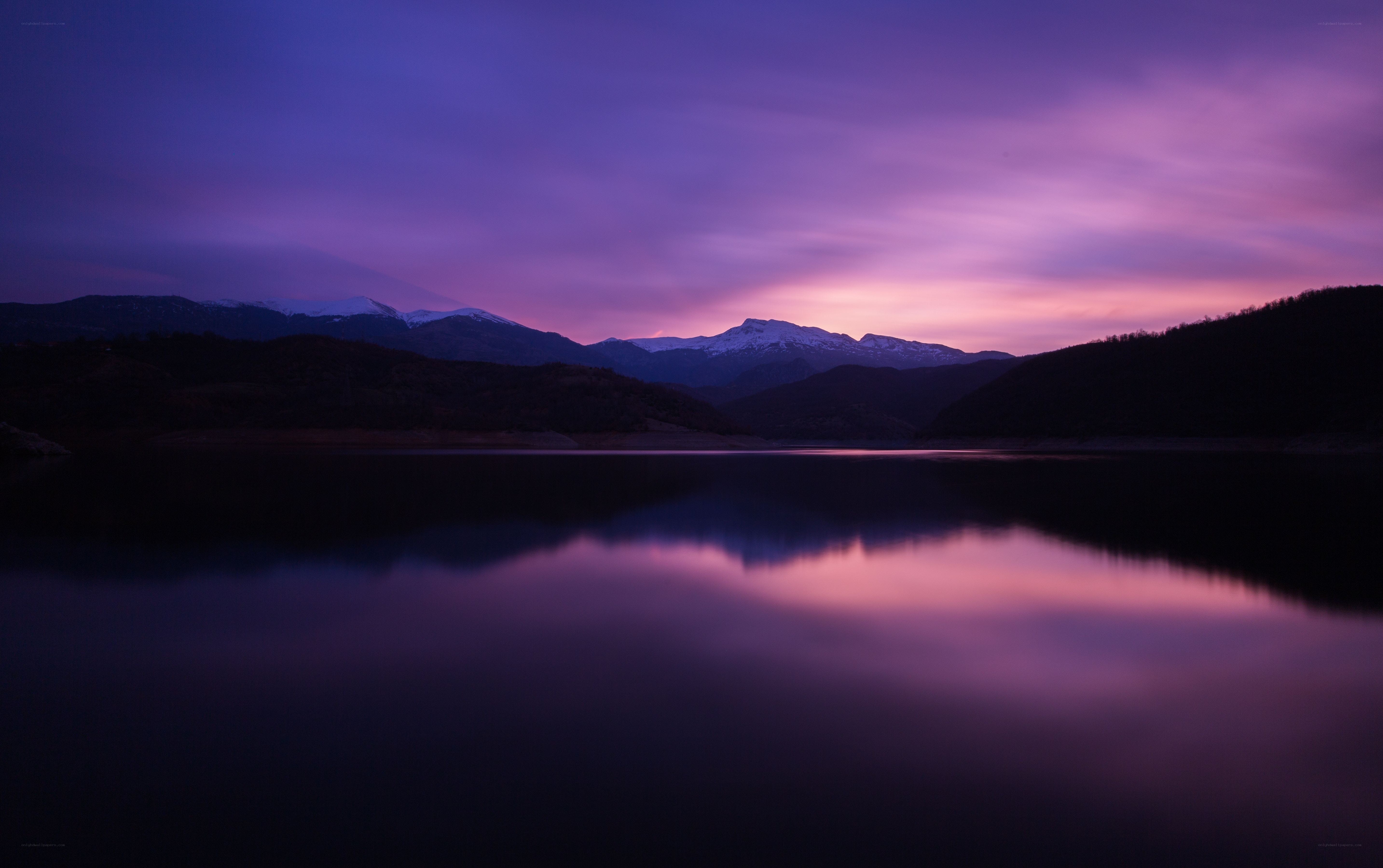 Purple sunset over mountain lake