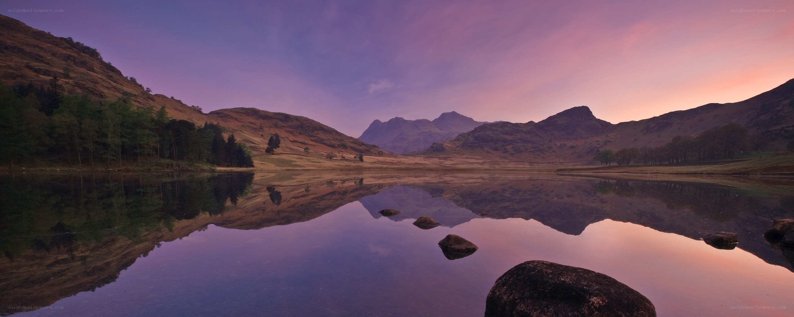Purple sunset over mountain lake