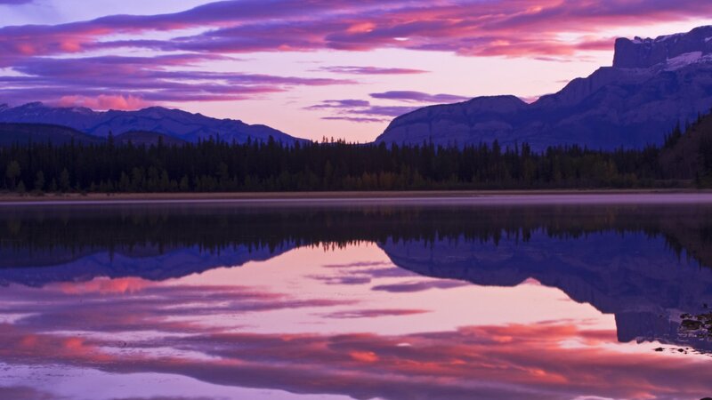Purple sunset over mountain lake