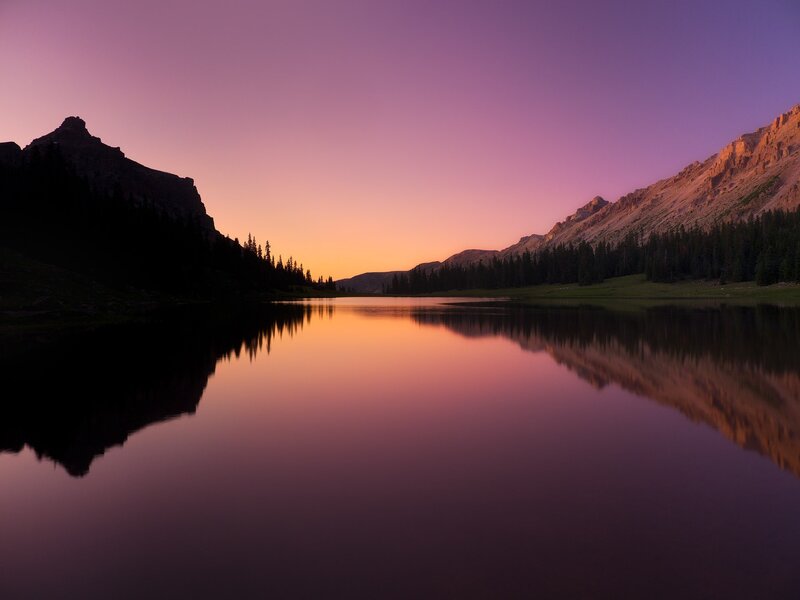 Purple sunset over mountain lake