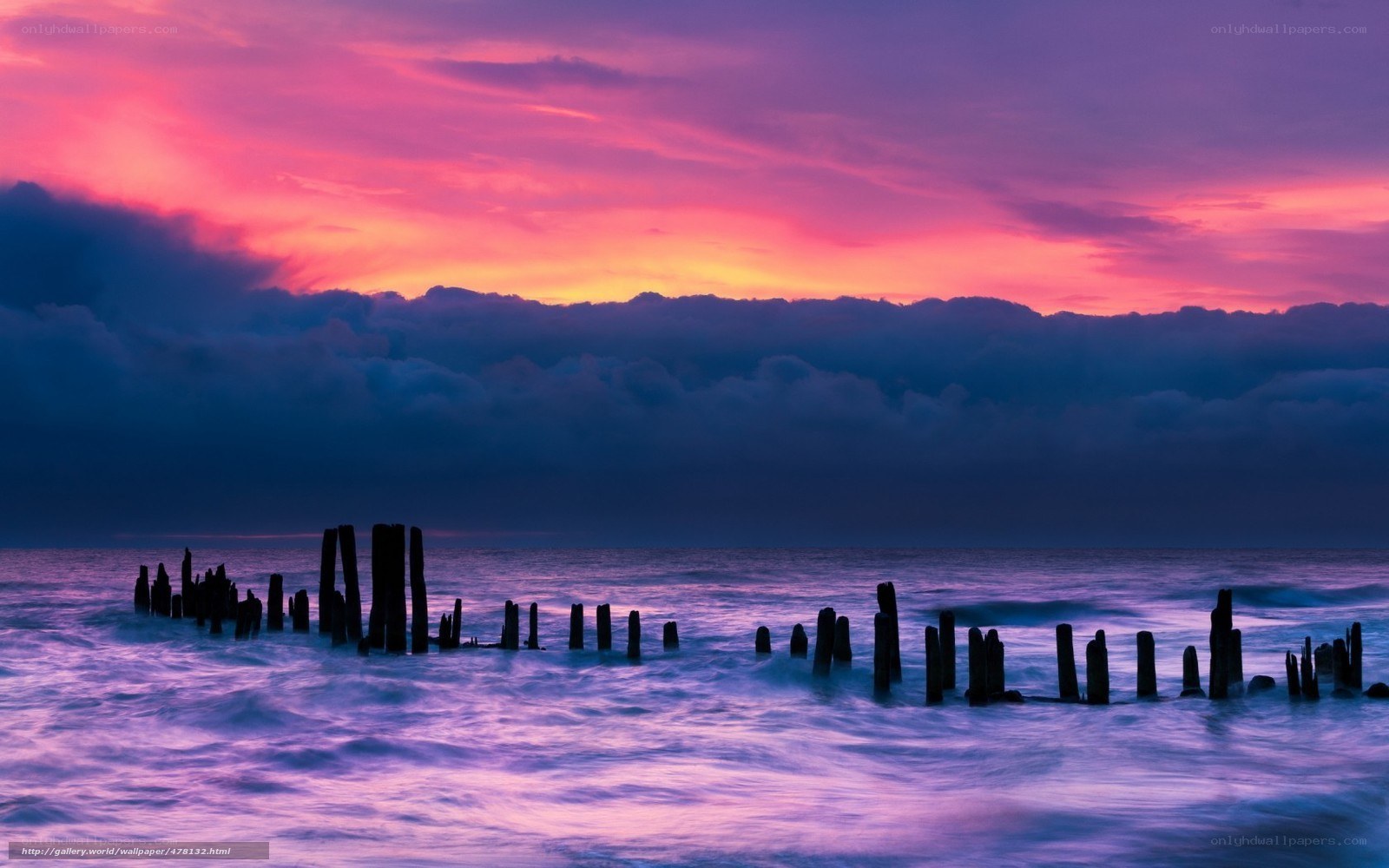 Purple sunset over ocean ruins