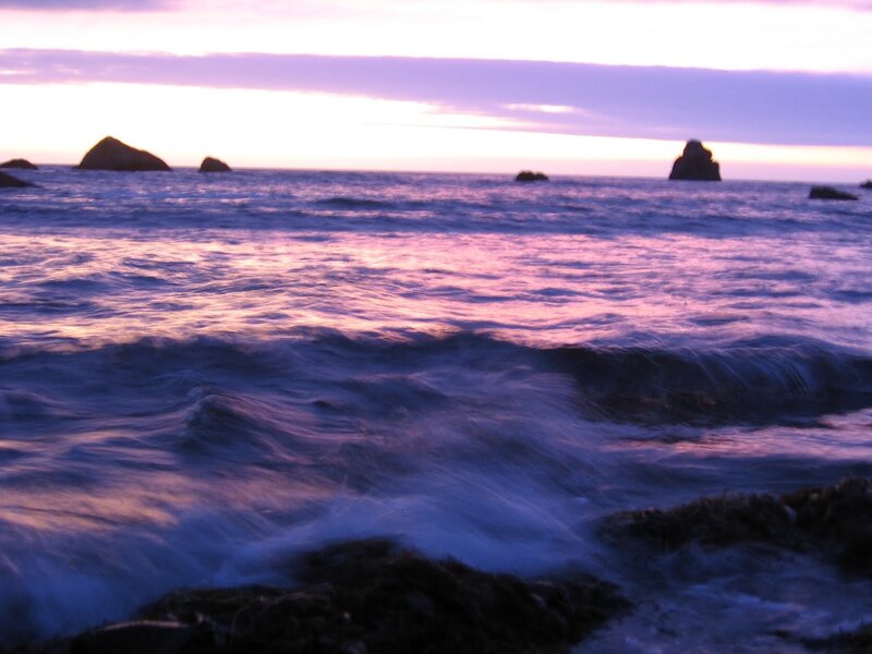 Purple sunset over ocean waves