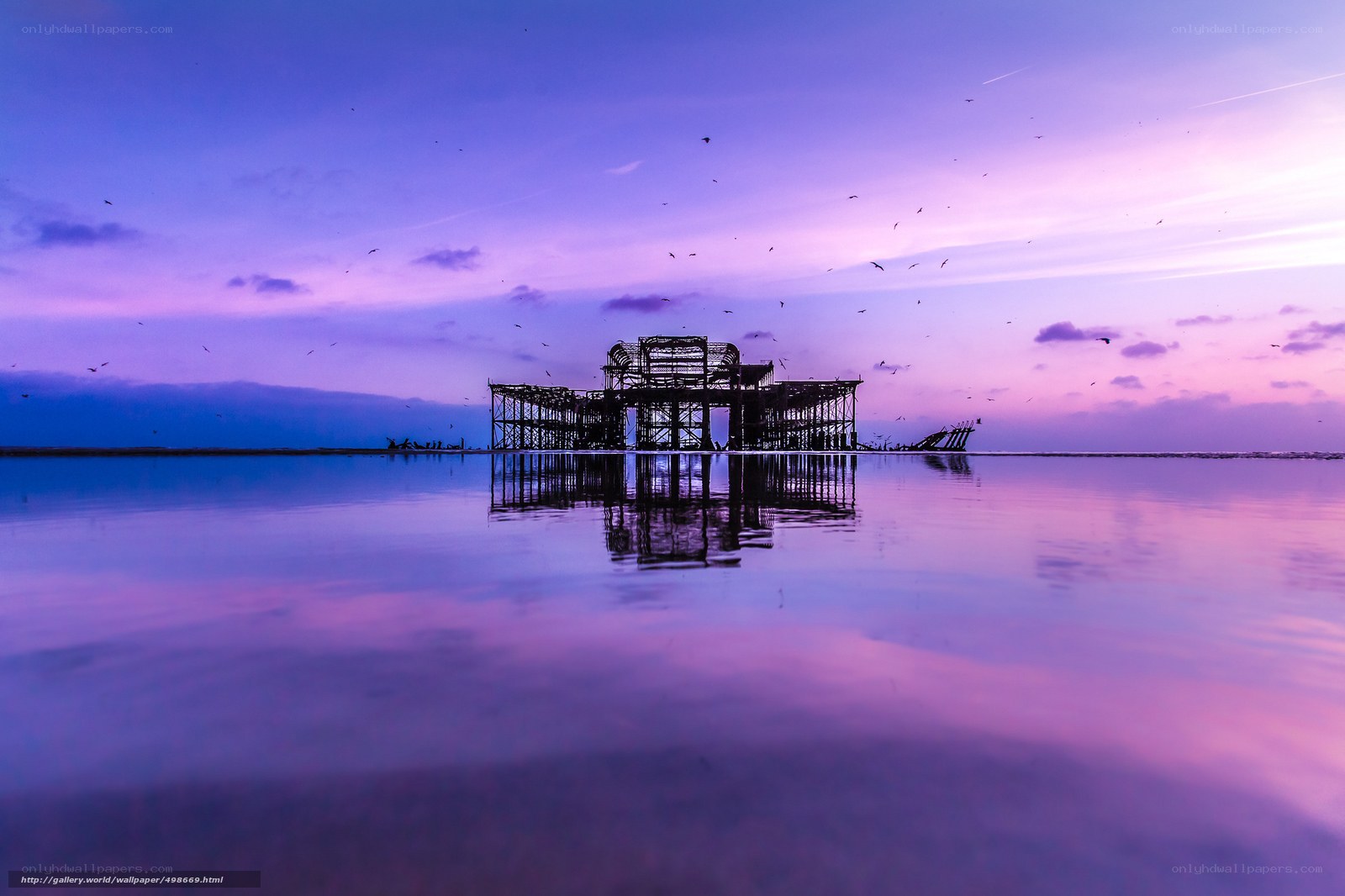 Purple sunset over pier ruins