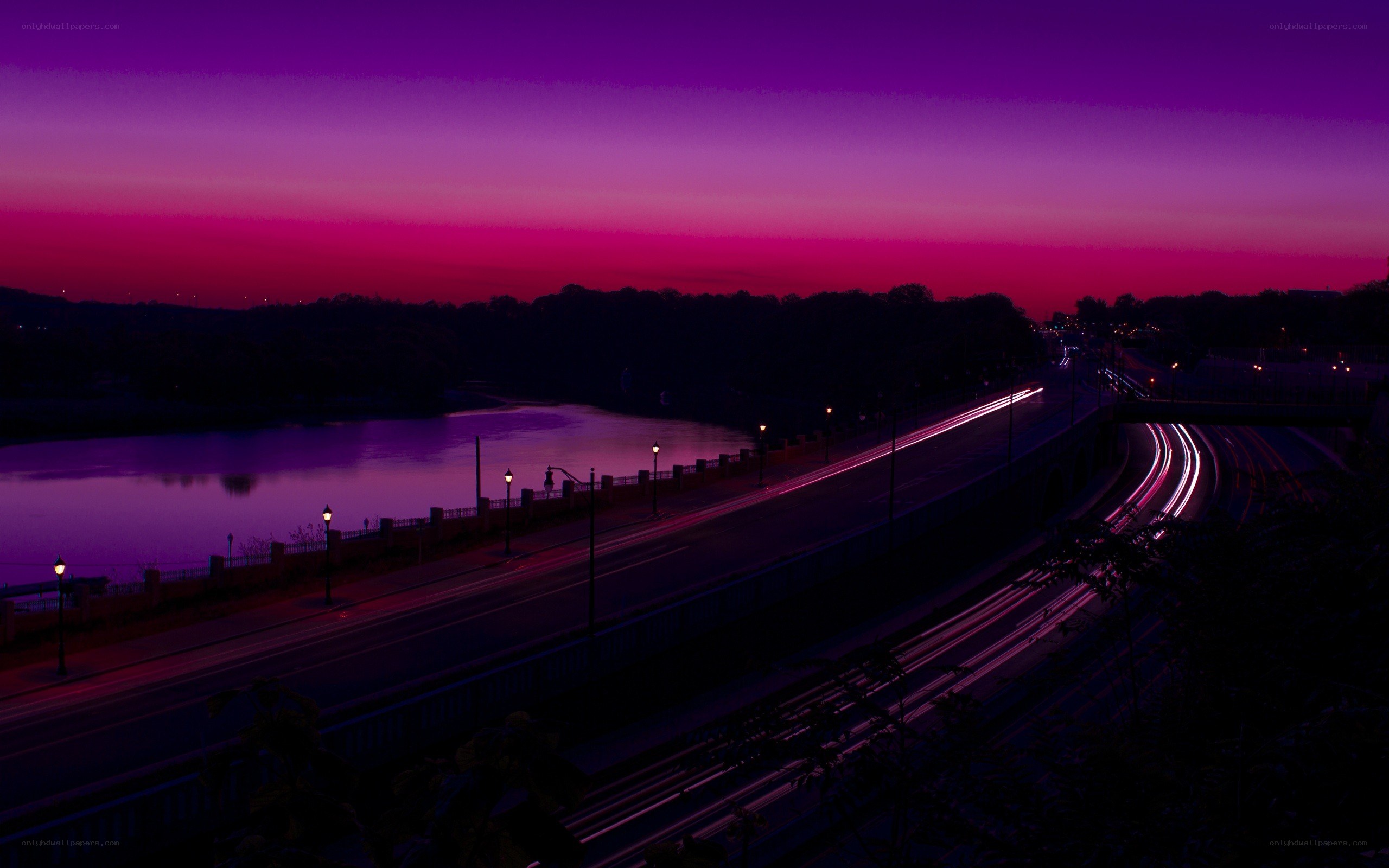 Purple sunset over river and highway
