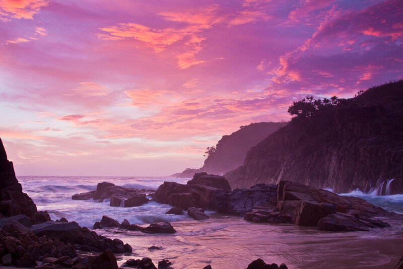 Purple sunset over rocky coast