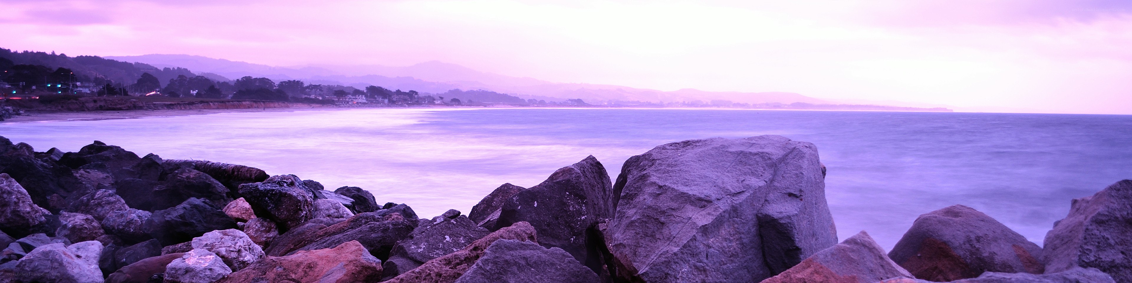 Purple sunset over rocky coast