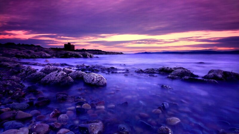 Purple sunset over rocky coast