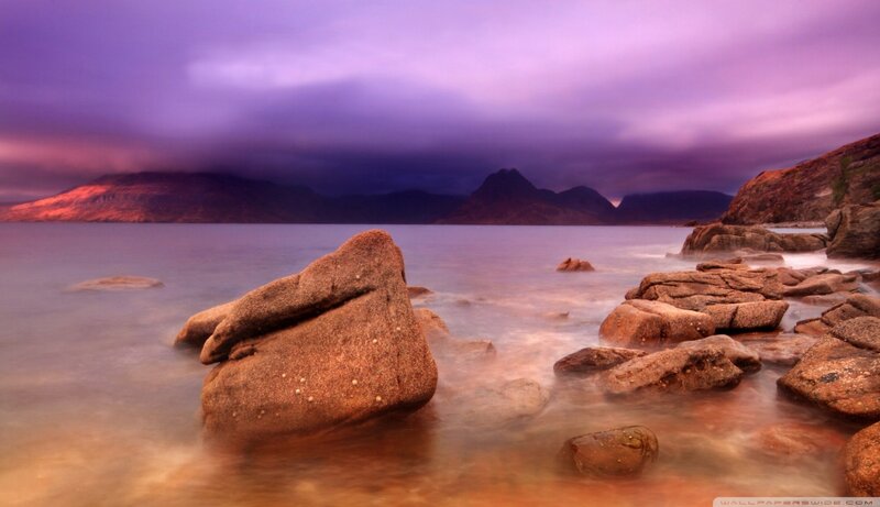 Purple sunset over rocky coast