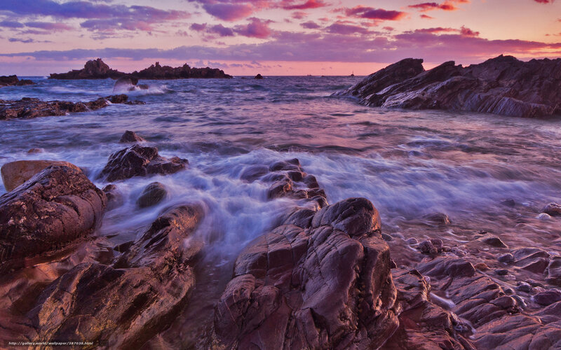 Purple sunset over rocky coast