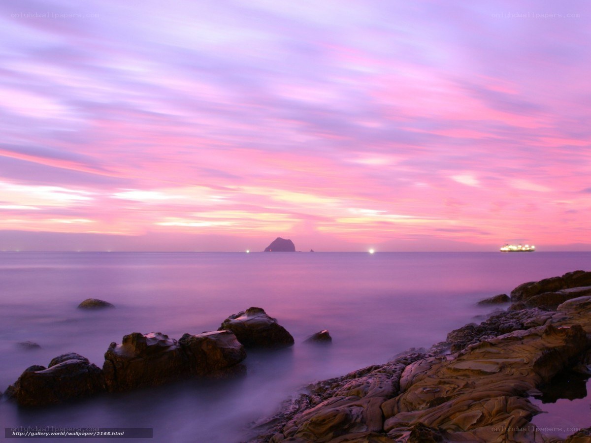 Purple sunset over rocky coast