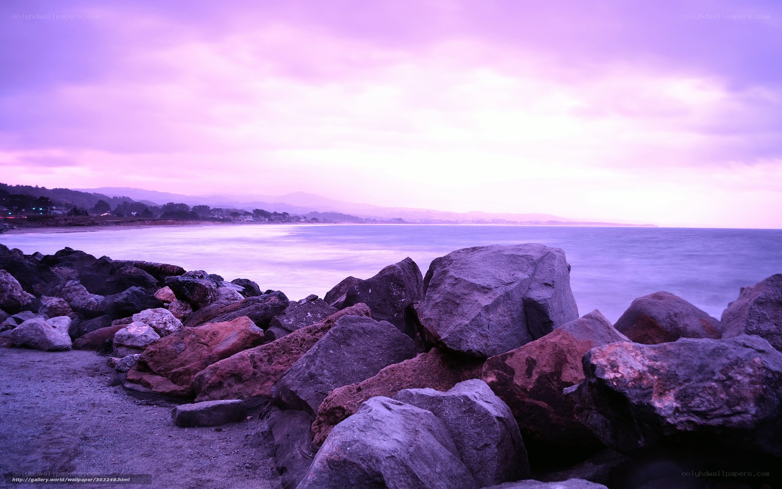 purple sunset over rocky shore