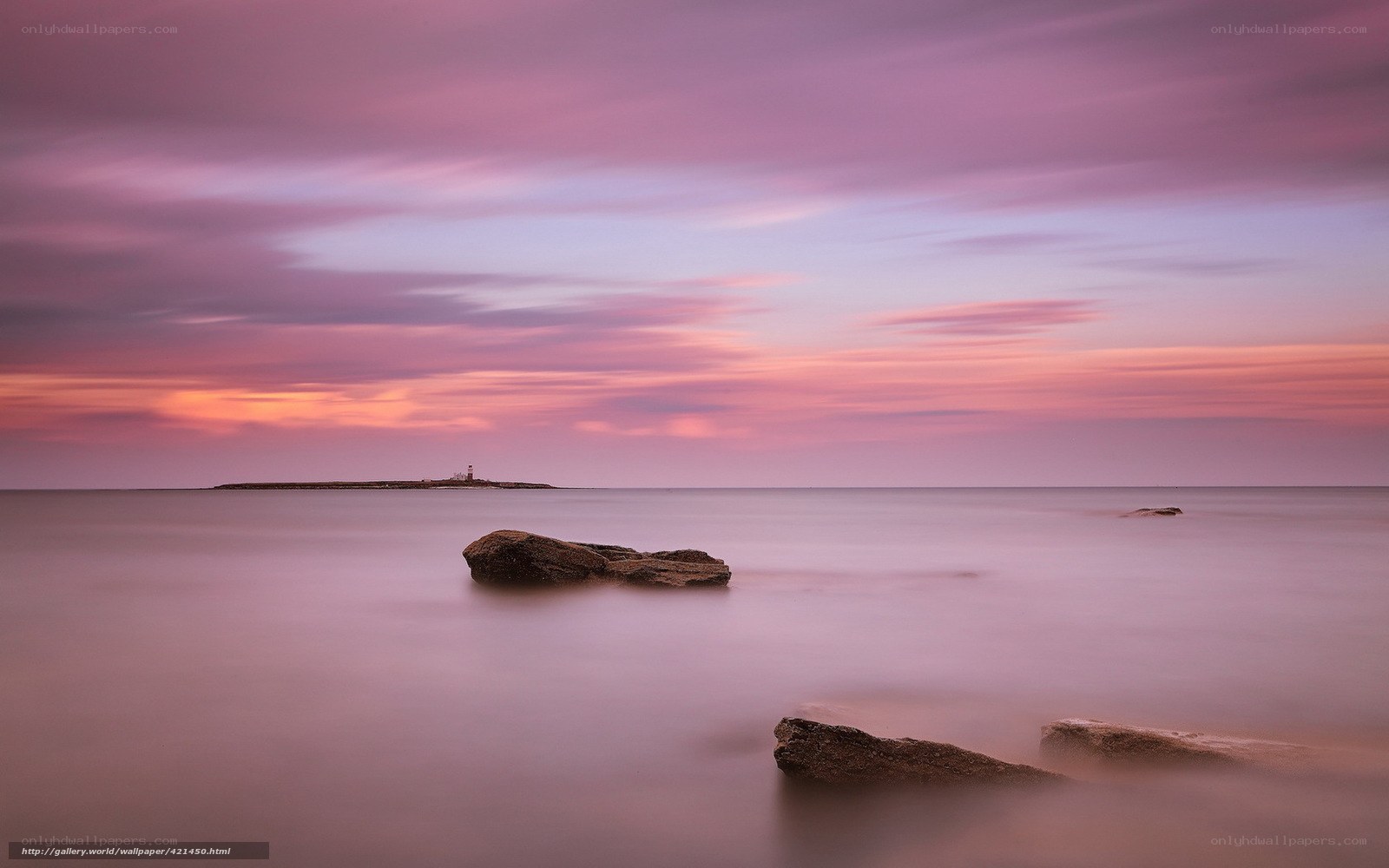Purple sunset over sea rocks