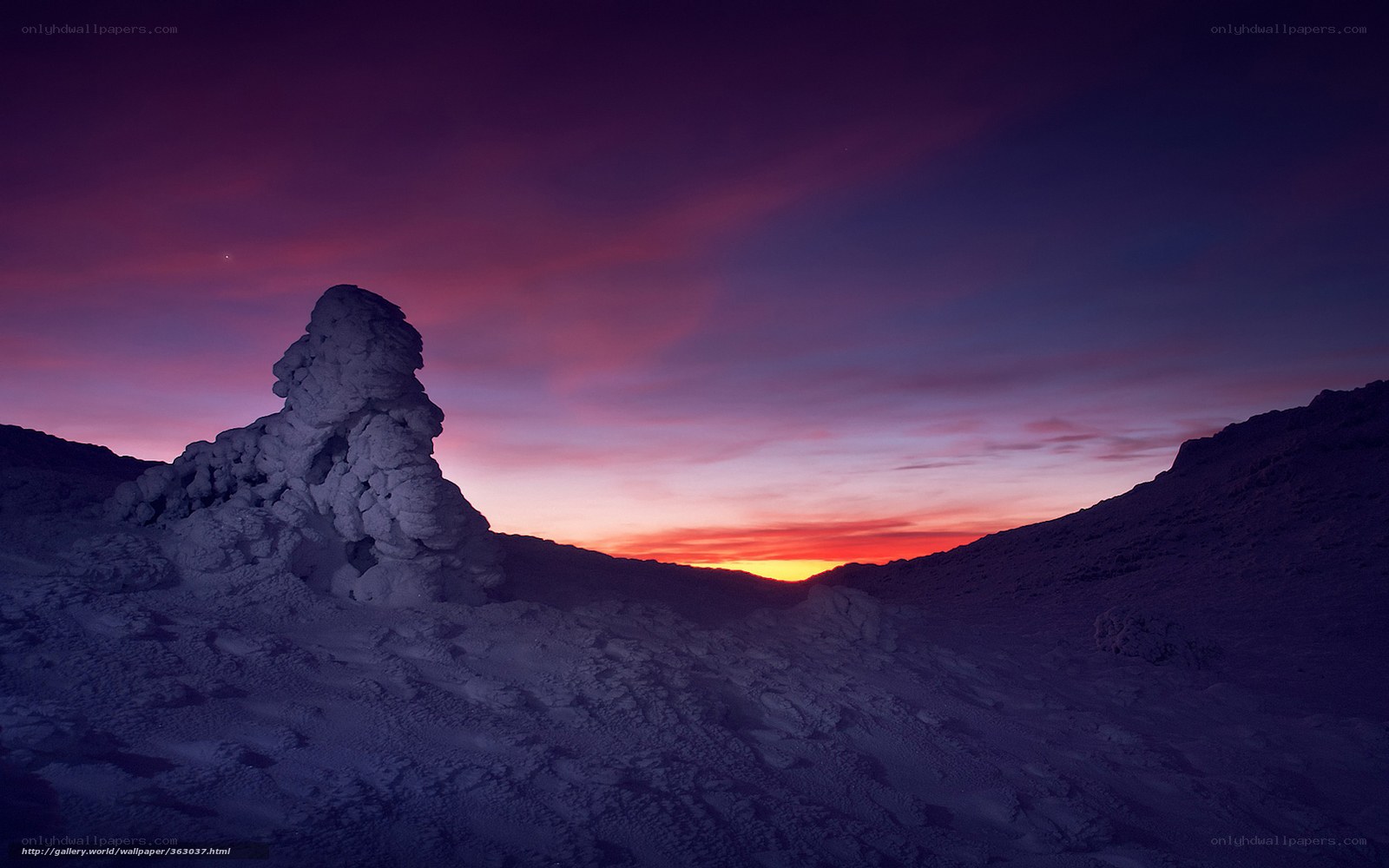 Purple sunset over snowy landscape