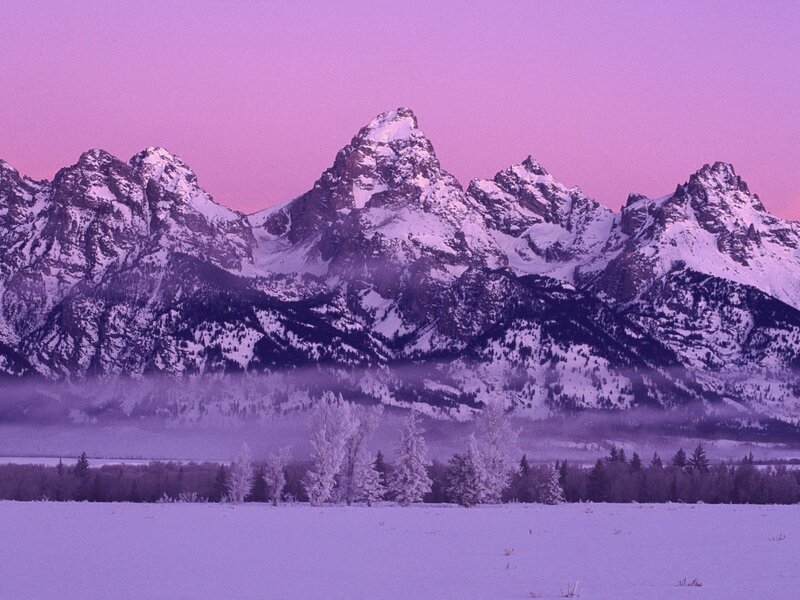 Purple sunset over snowy mountains