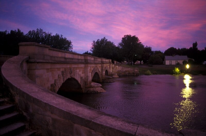 Purple sunset over stone bridge
