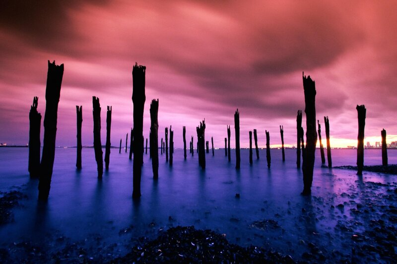 Purple sunset over wooden posts