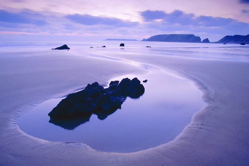 Purple-tinted beach at dusk