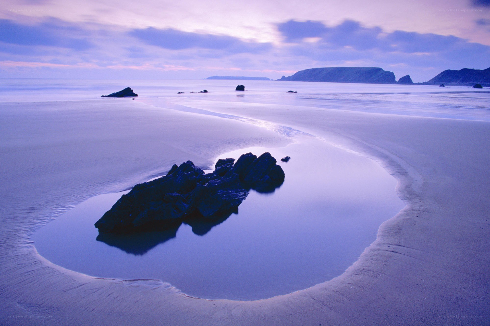 Purple-tinted beach at dusk