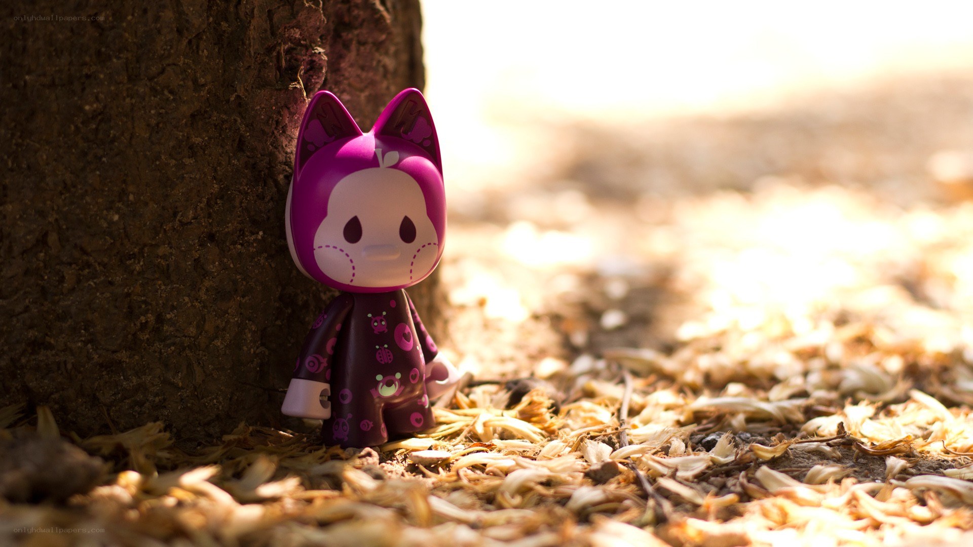 Purple toy figure by a tree