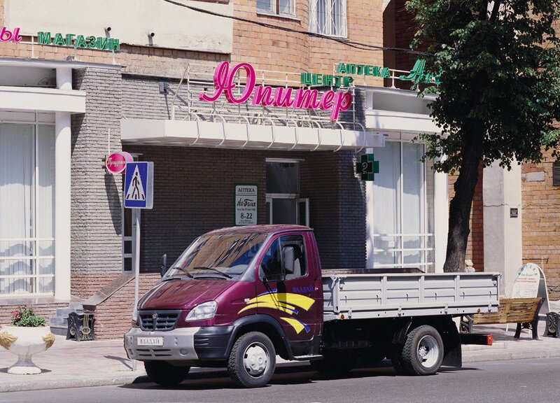 Purple truck parked in front of a pharmacy