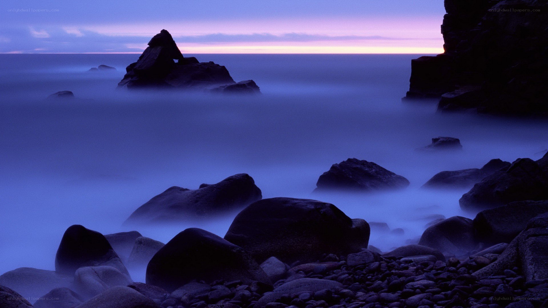 Purple twilight at rocky coast