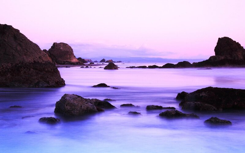 Purple twilight at the rocky shore