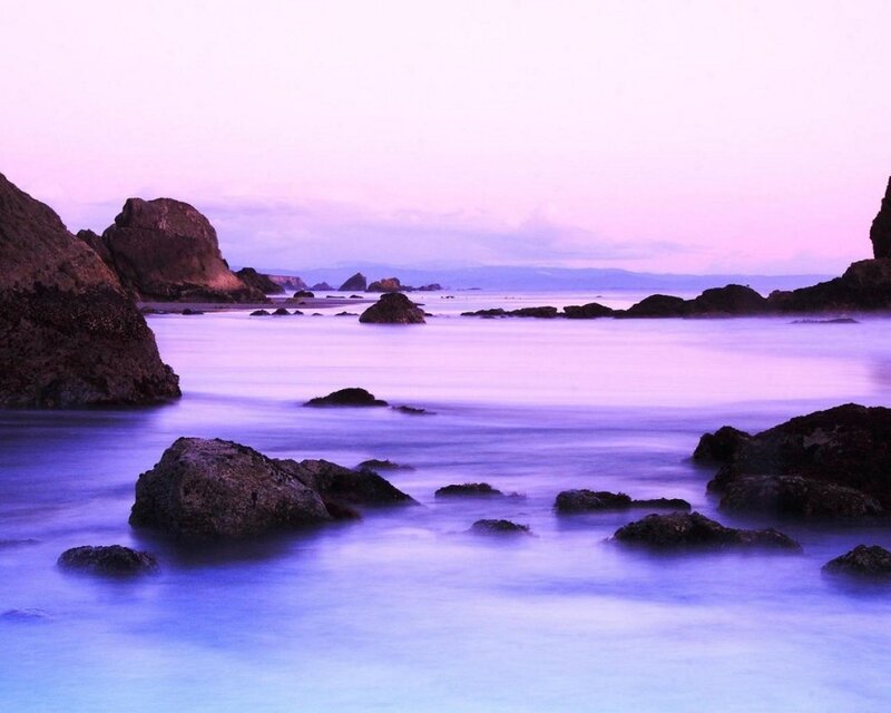 Purple twilight at the rocky shore