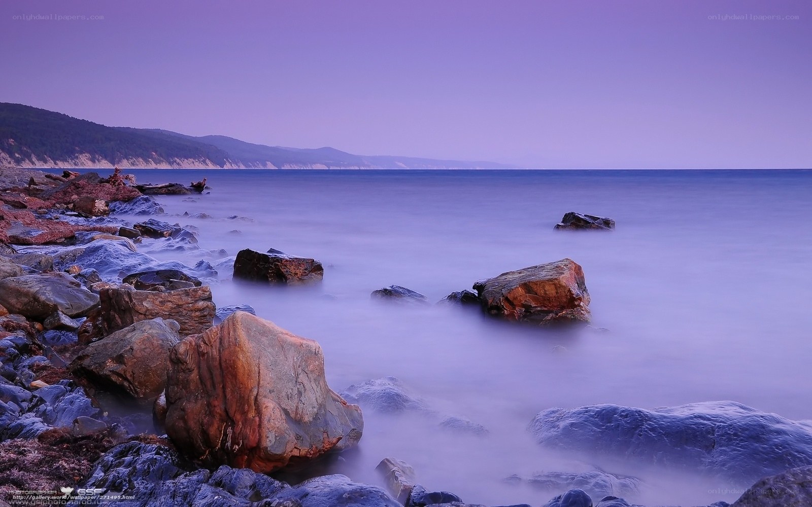 Purple twilight at the rocky shore
