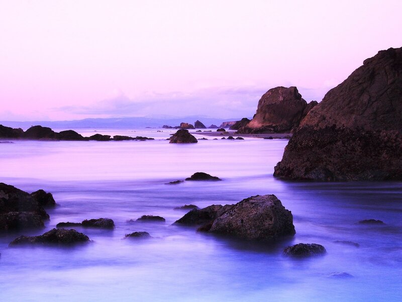 Purple twilight at the rocky shore