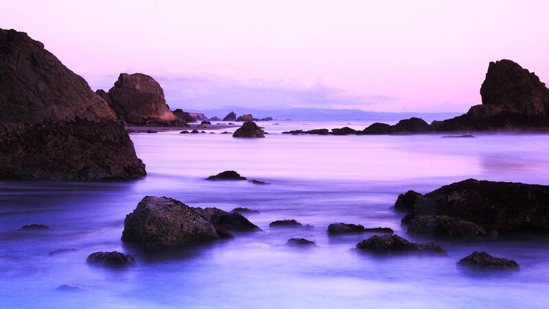 Purple twilight at the rocky shore