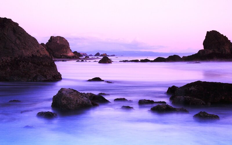 Purple twilight at the rocky shore