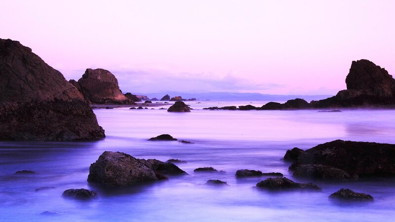 Purple twilight at the rocky shore