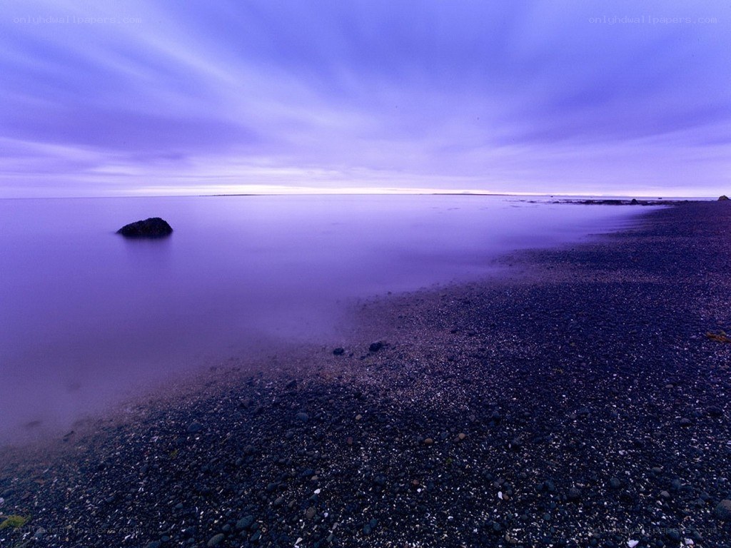 Purple twilight on a pebble beach