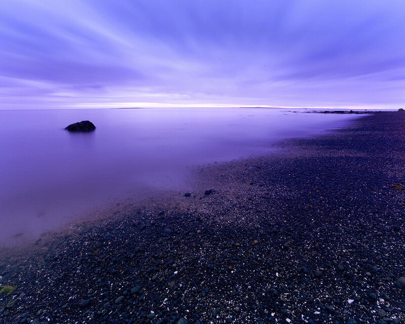 Purple twilight on a pebble beach