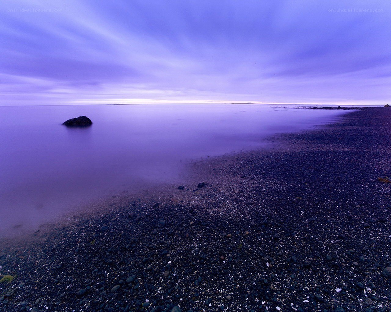Purple twilight on a pebble beach