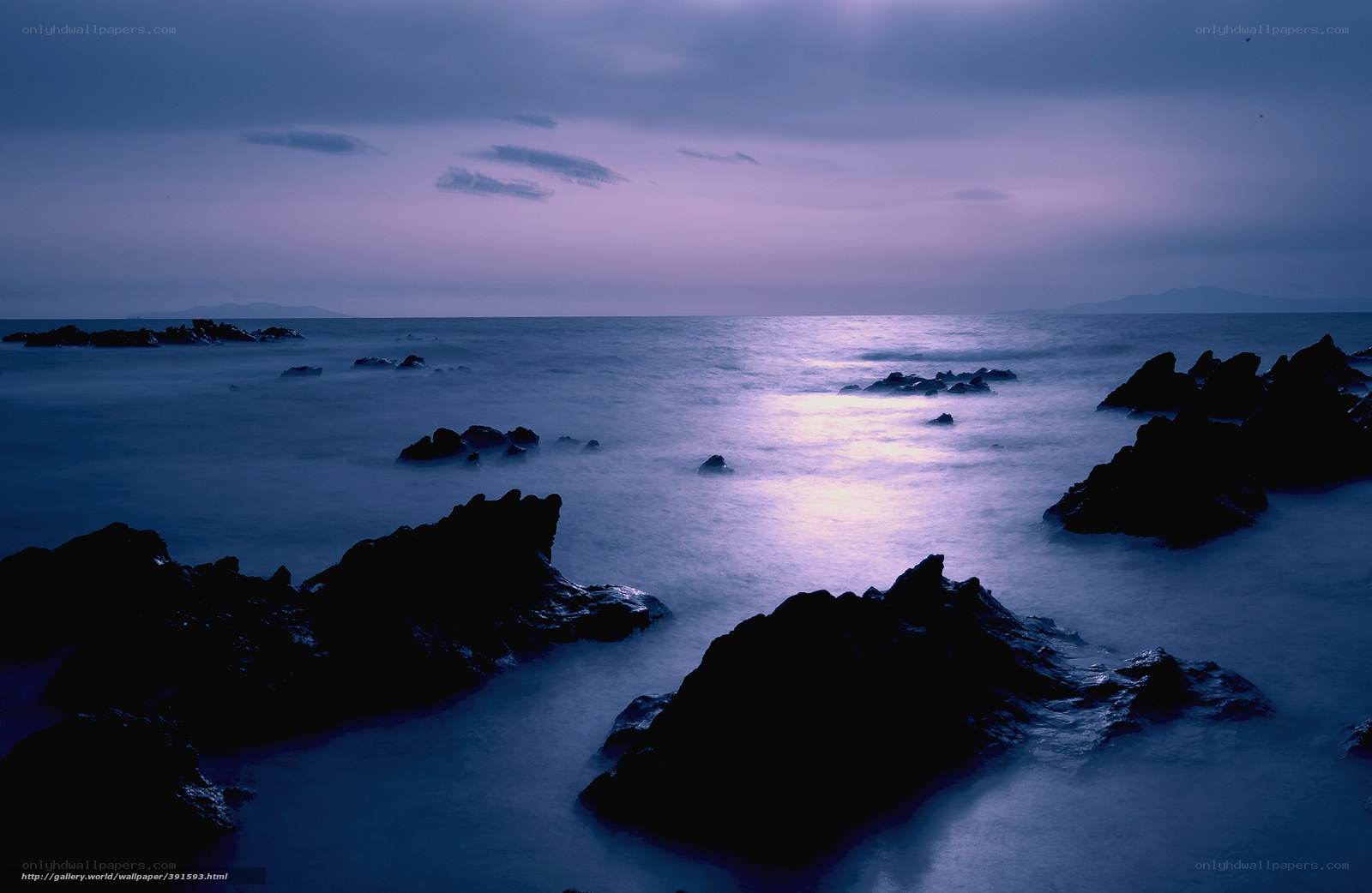 Purple twilight over rocky shore