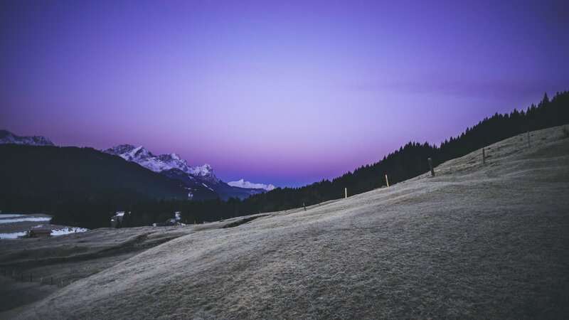 purple twilight over snowy mountains
