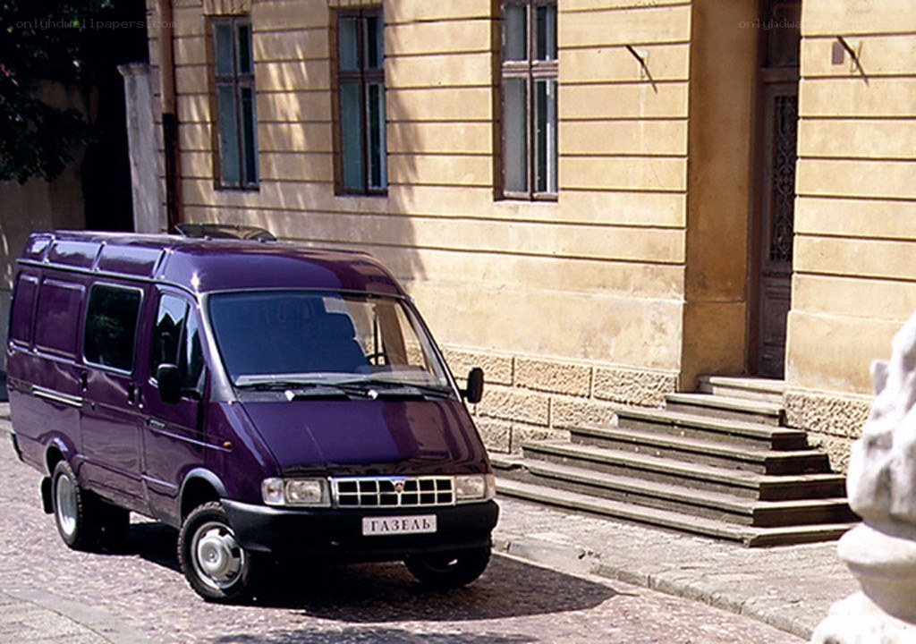 Purple van parked on cobblestone street