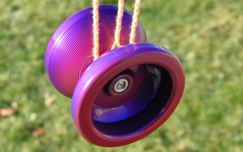 Purple yo-yo hanging on string