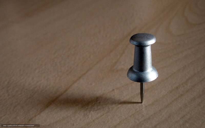 push pin on wooden surface