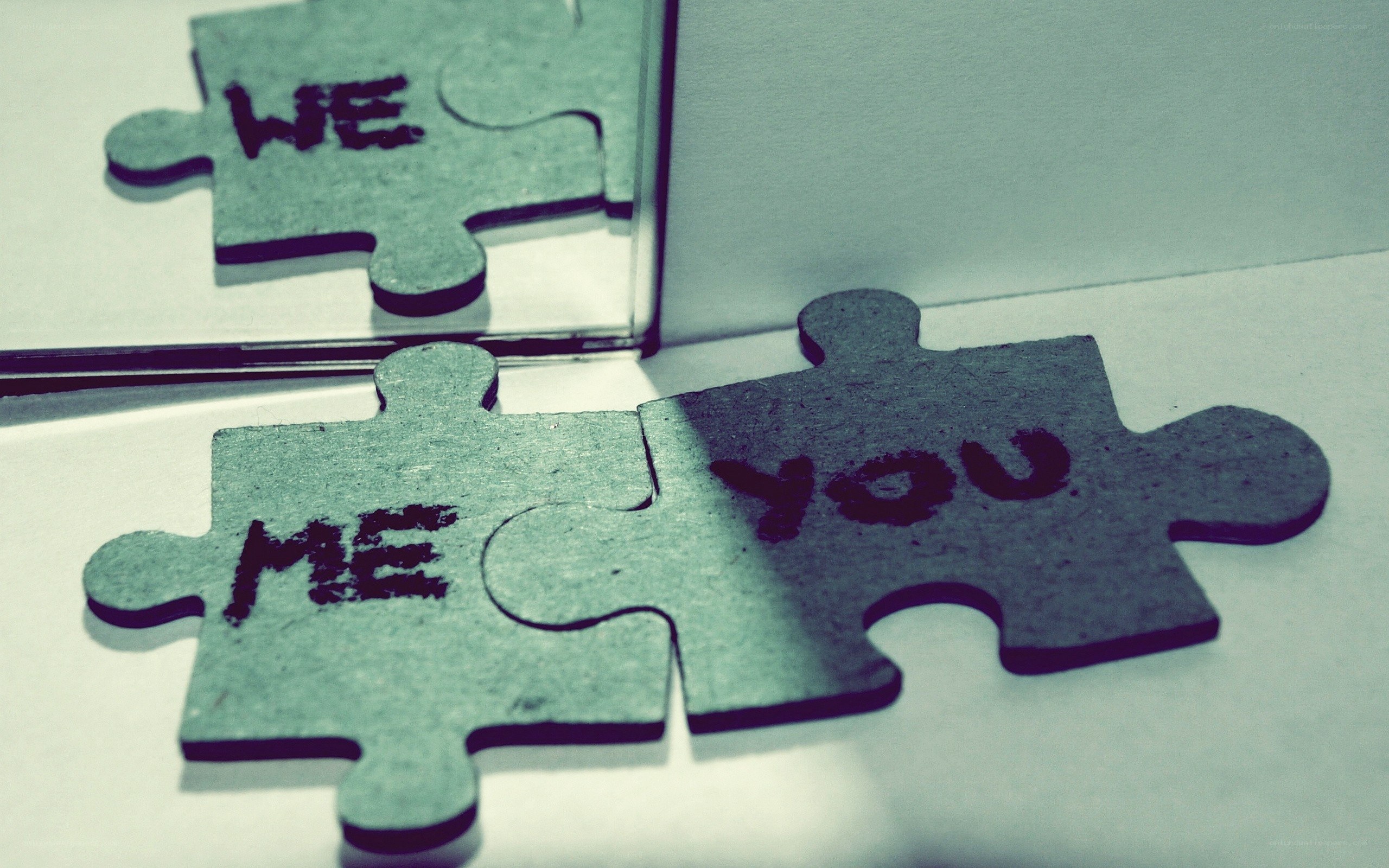 Puzzle pieces with 'me', 'you', 'we'