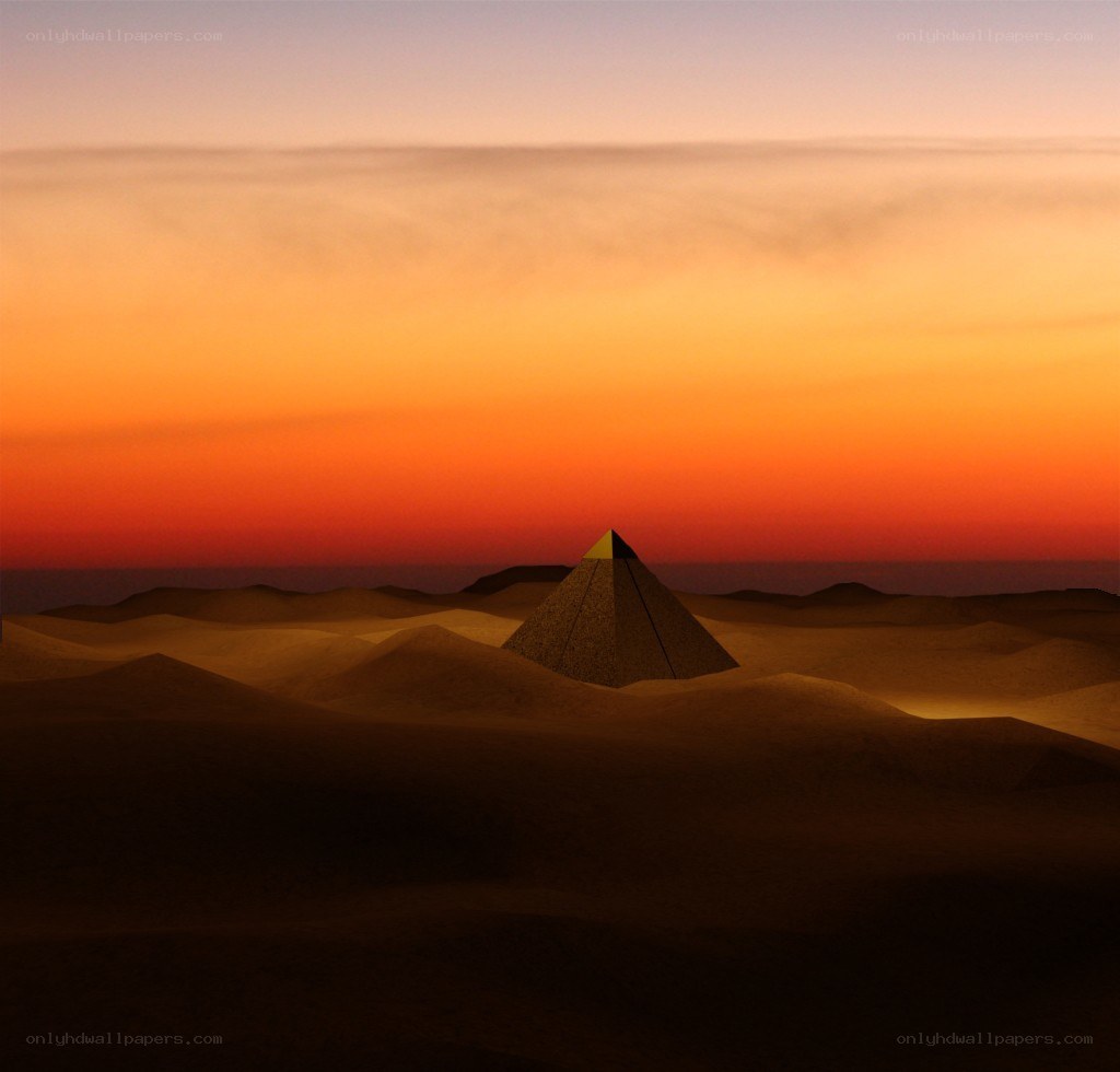 Pyramid in desert at sunset