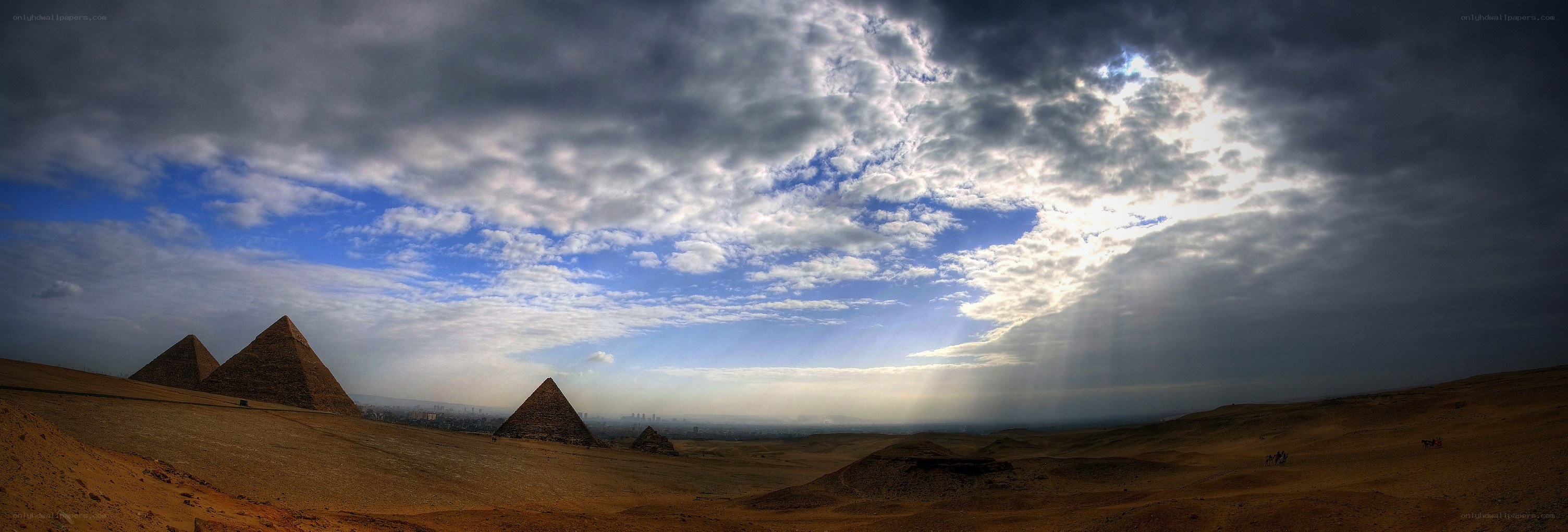 Pyramids of Giza under dramatic sky