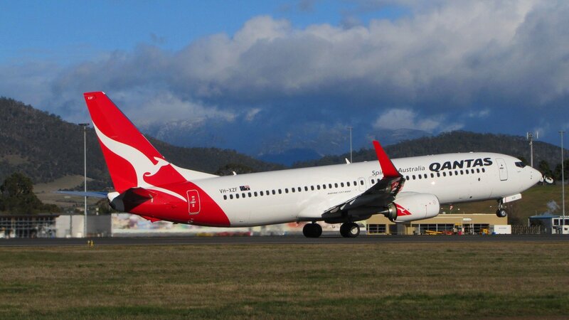 Qantas Airplane on Runway — White, Dramatic