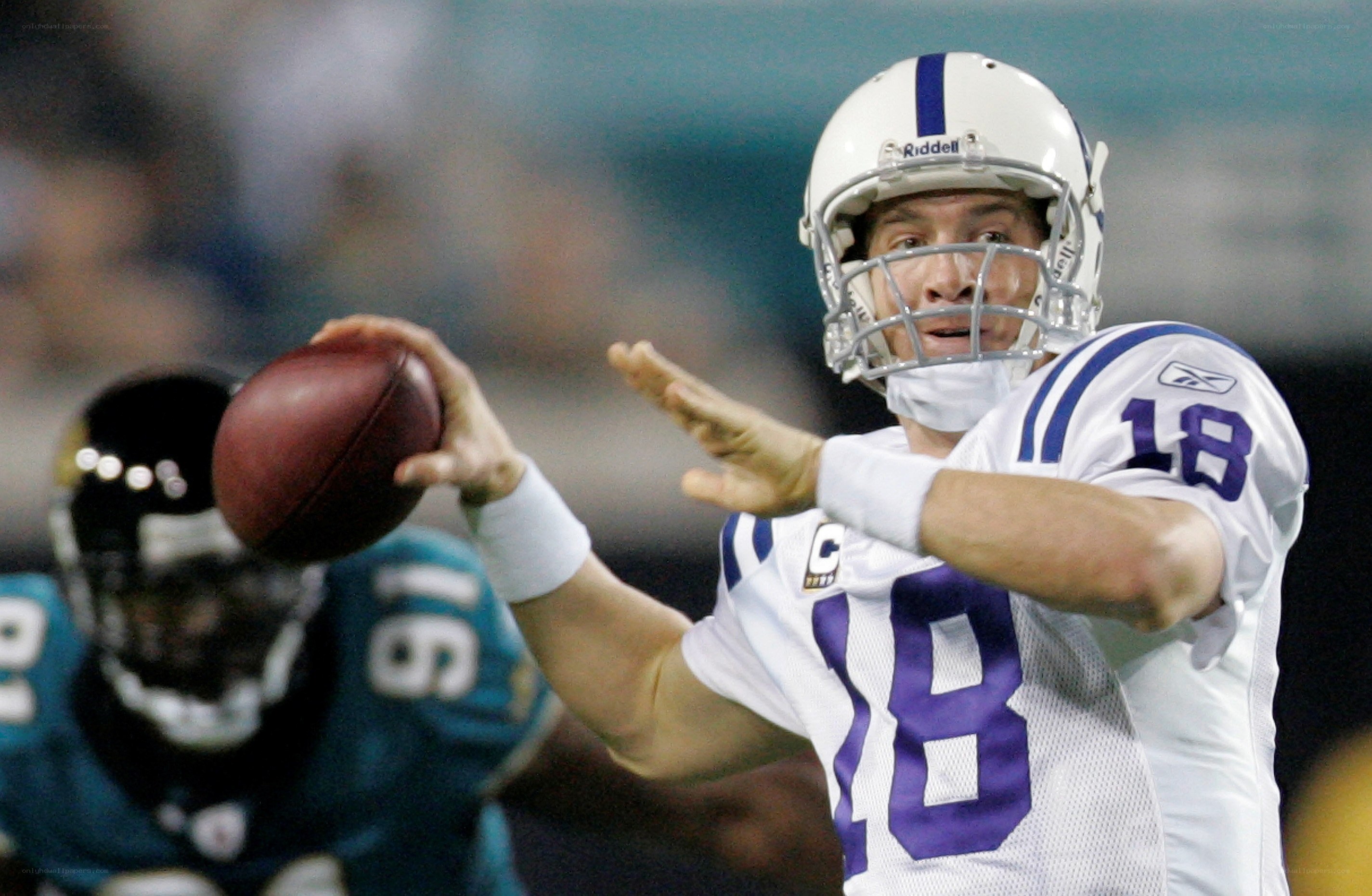 Quarterback throwing football