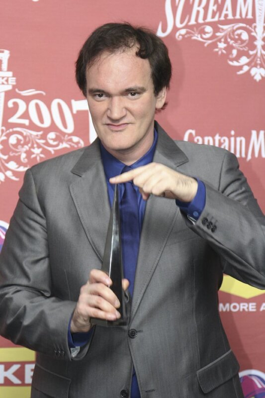 Quentin Tarantino holding award