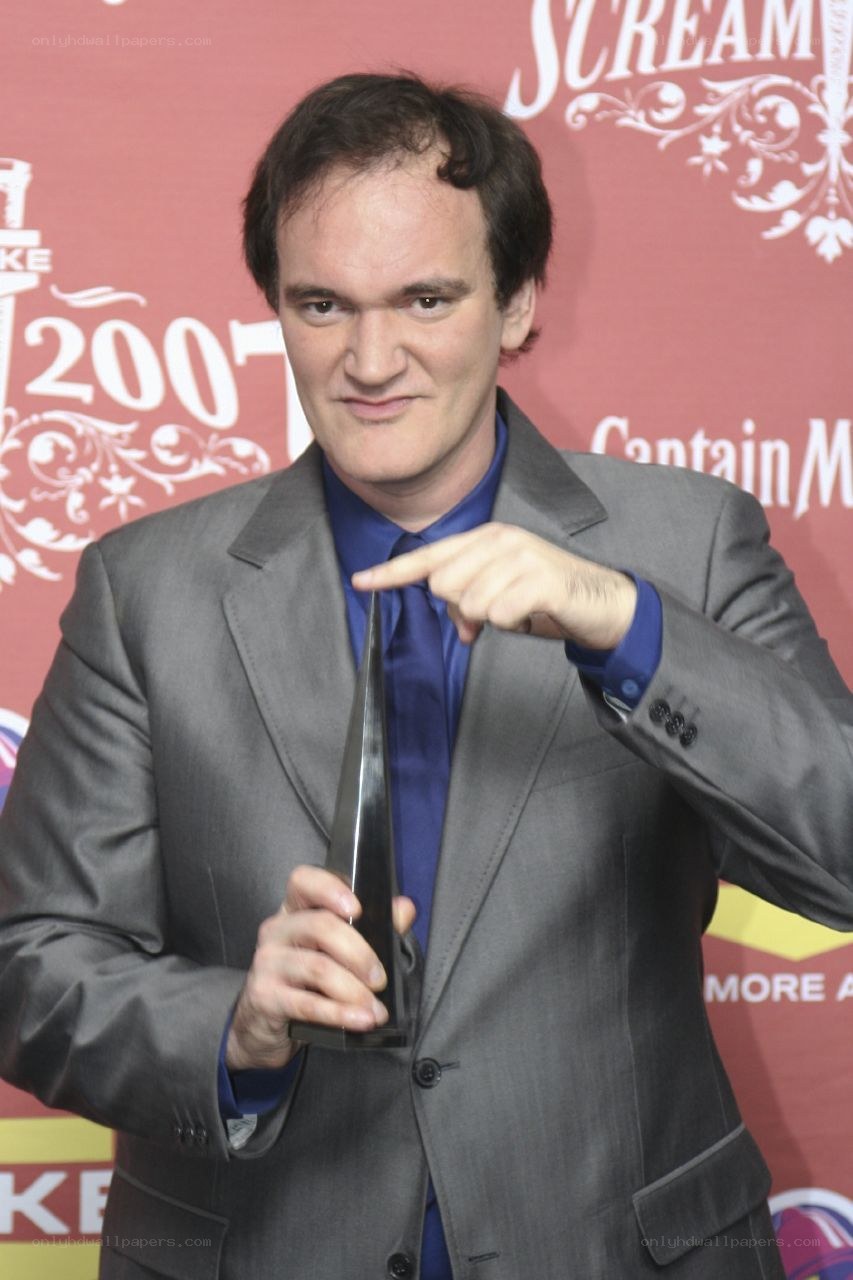 Quentin Tarantino holding award
