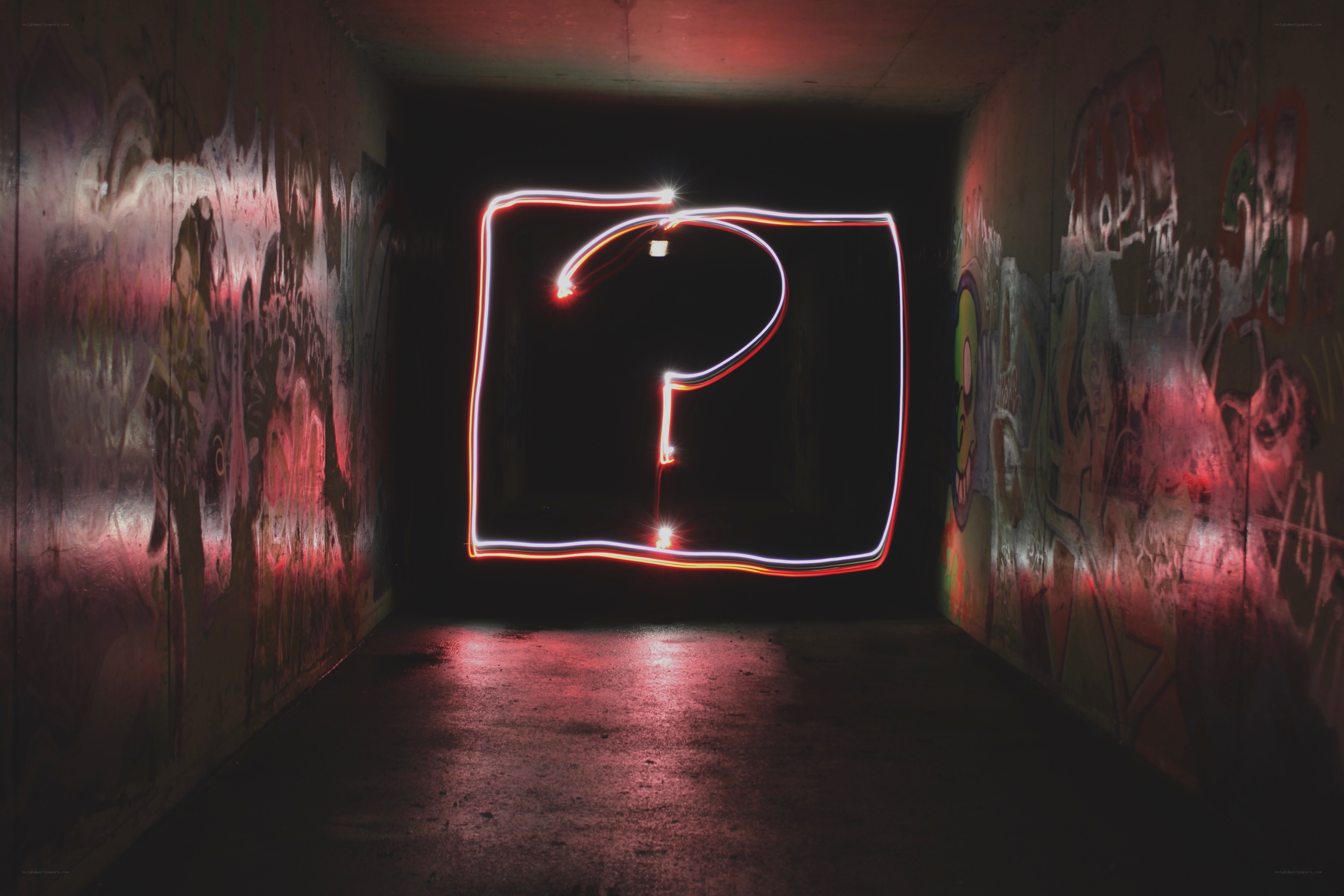 Question mark in dark tunnel